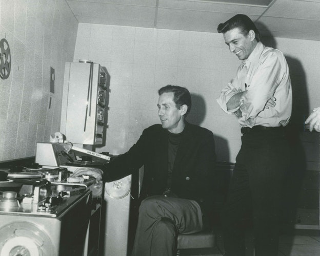 Chet Atkins and Waylon Jennings in recording studio booth, RCA-Victor.
